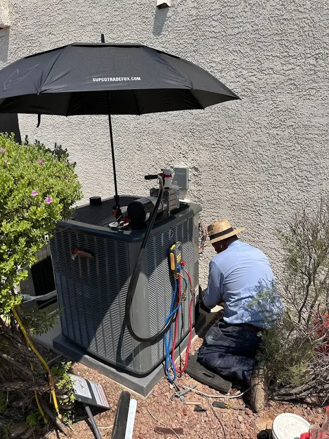 HVAC technician performing outdoor AC maintenance in Hooper